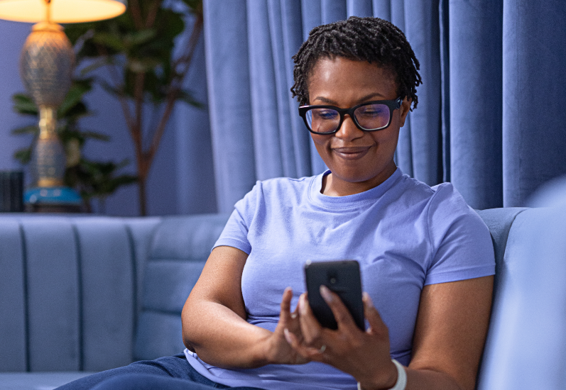 Eversense user easily applies removable CGM device in front of a mirror.